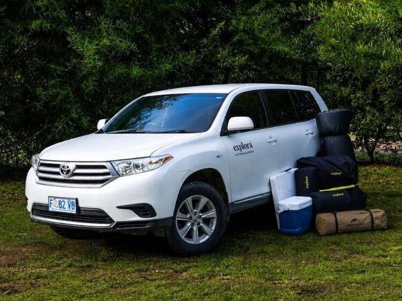 Explora SUV with its camping gear laid out beside it