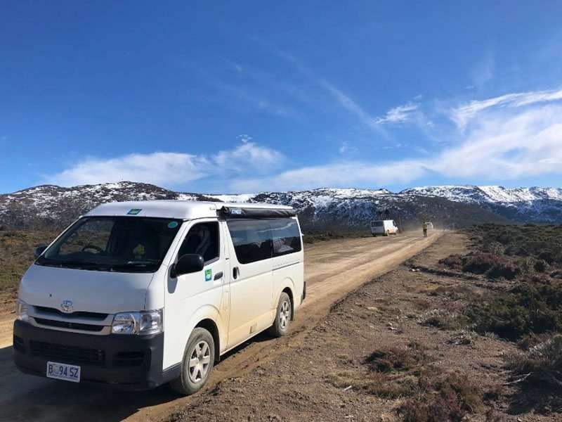 Tasmanian Campervan Hire Toyota HiAce campervan with snowy mountains behind